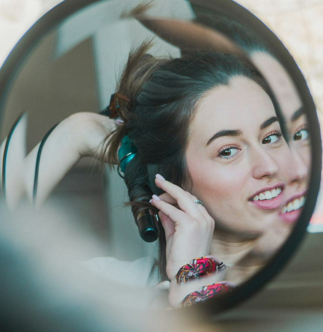 a woman looking through a mirror