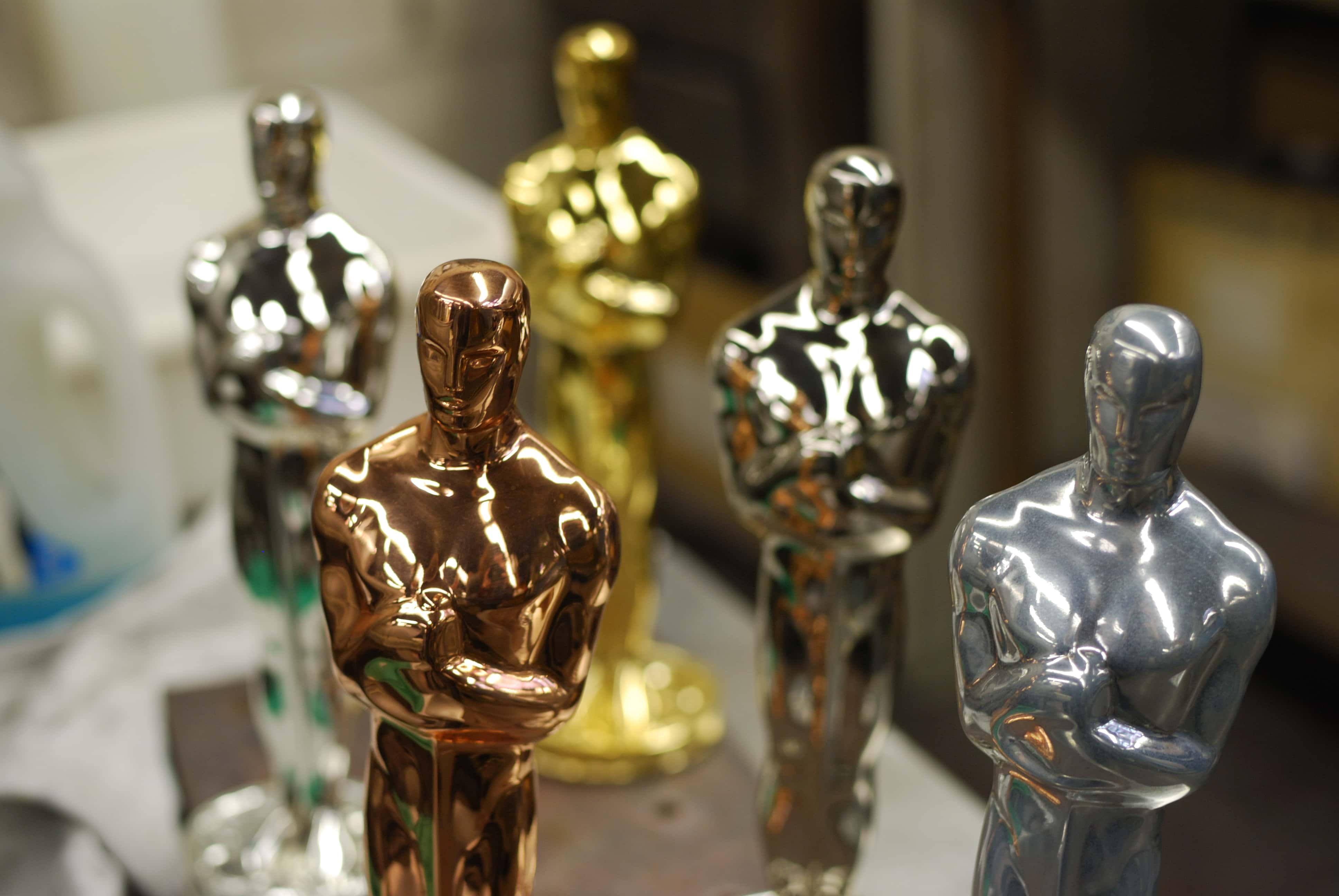 Oscar statuettes at various stages of plating - copper, nickel, silver and 24-carat gold.