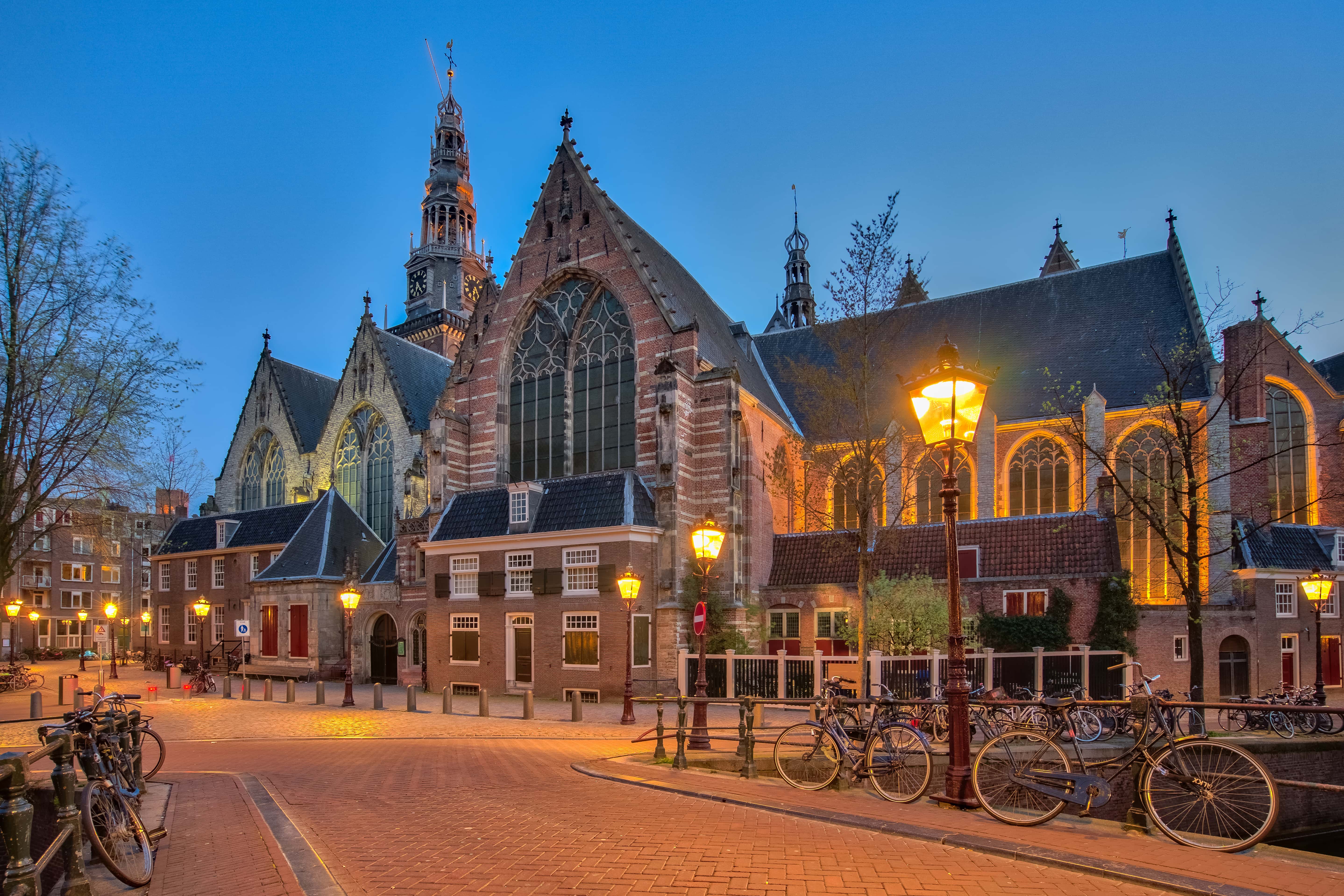 The old church Oude Kerk in Amsterdam city at night, Netherlands.