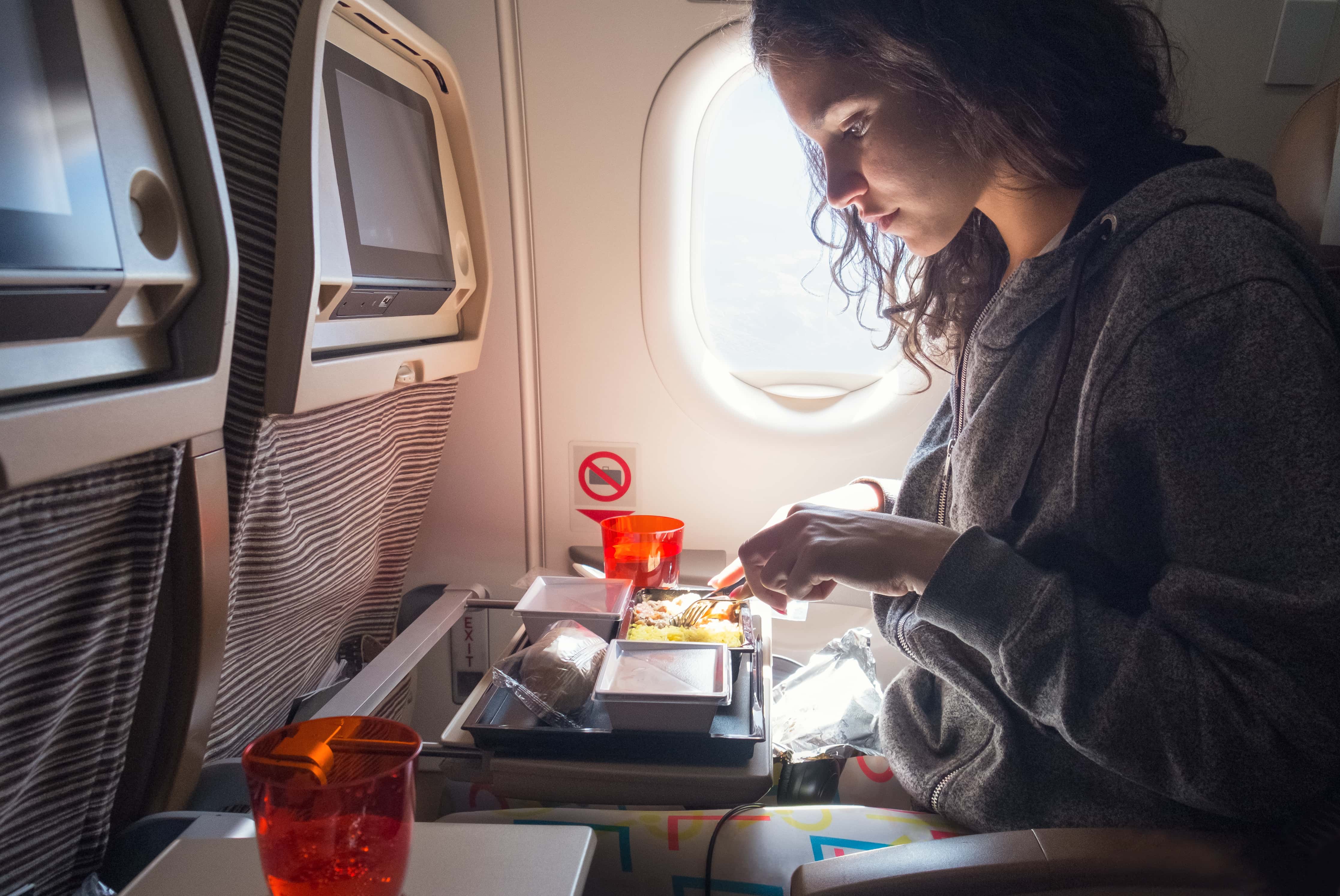 Woman eating lunch in airplane