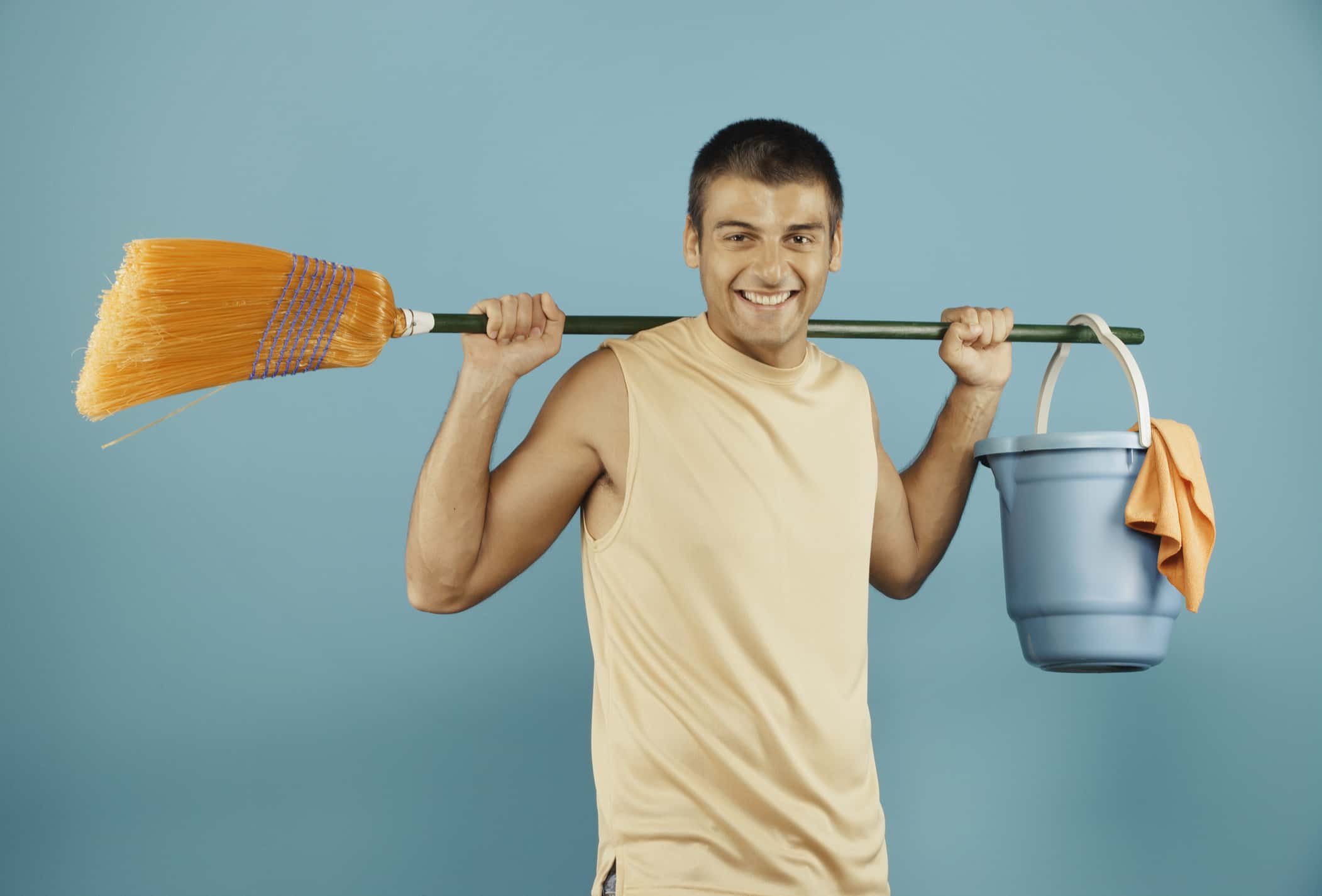 Young man with broom and bucket
