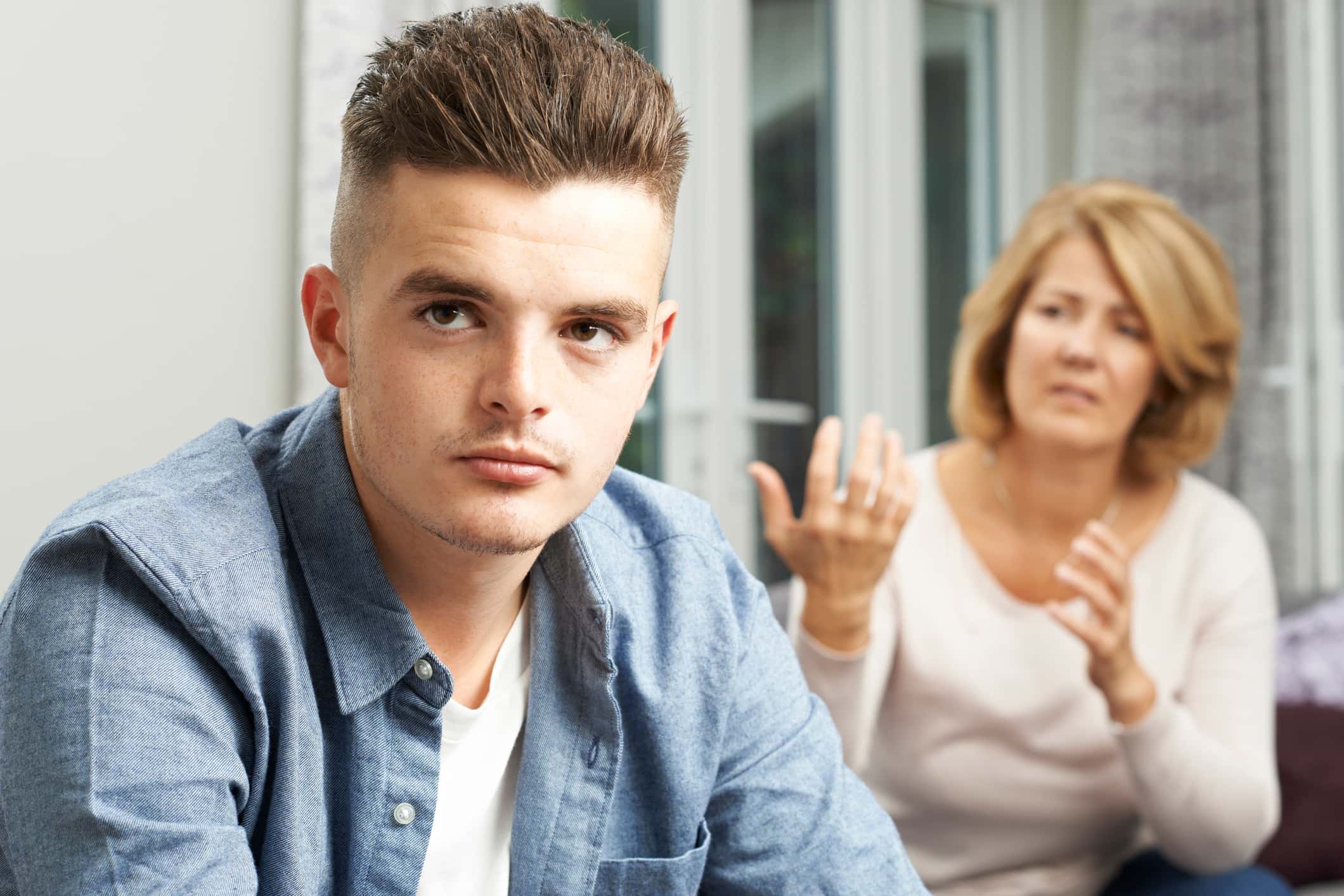 Bored Teenage Boy Being Told Off By Mother