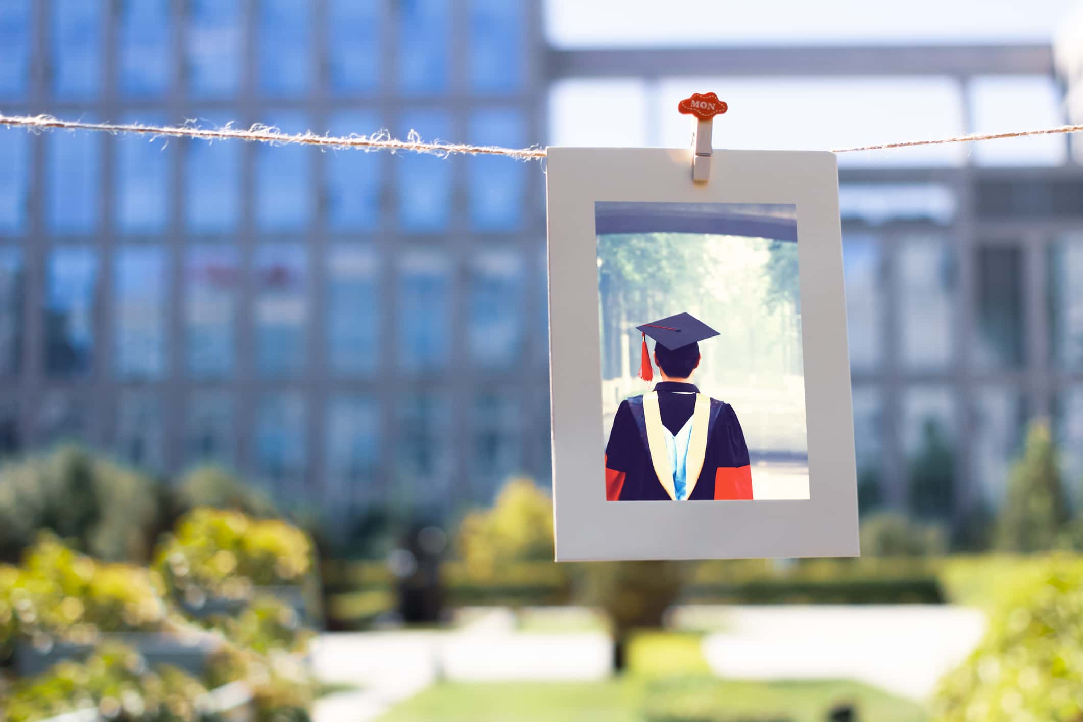 Ph.D student graduation picture hanging on a string.